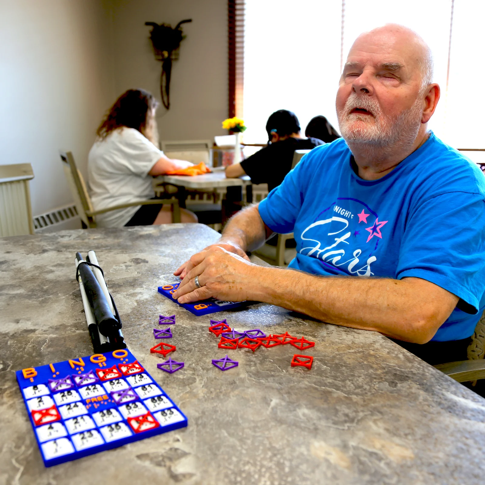 Braille bingo board man using board